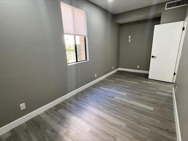 spare room with hardwood / wood-style floors