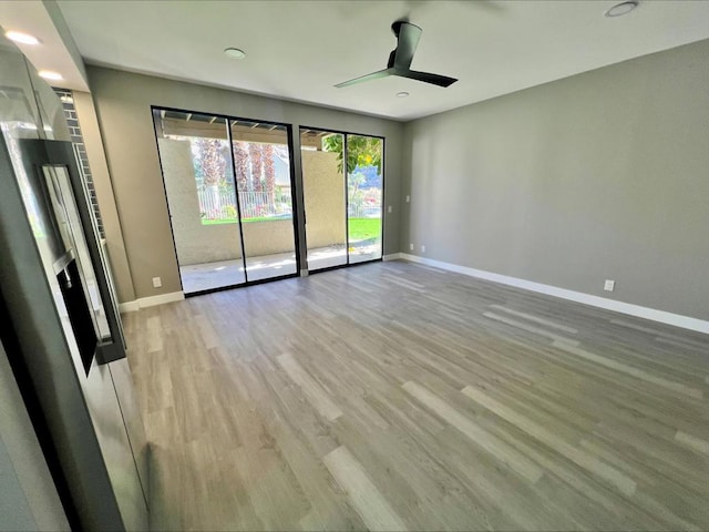 unfurnished room featuring light wood-type flooring and ceiling fan