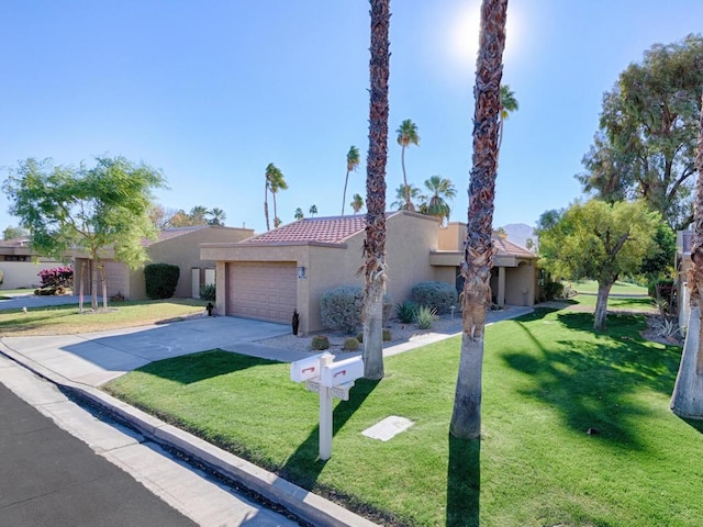 view of front of house featuring a garage and a front lawn