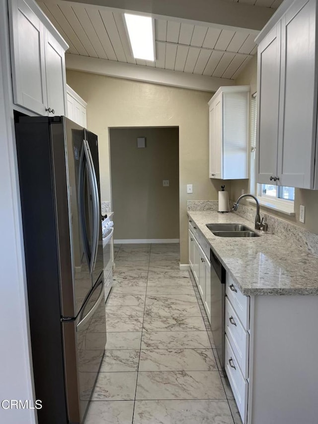 kitchen with sink, light stone counters, beamed ceiling, white cabinets, and appliances with stainless steel finishes