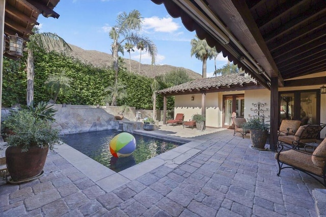 exterior space featuring a mountain view and a patio