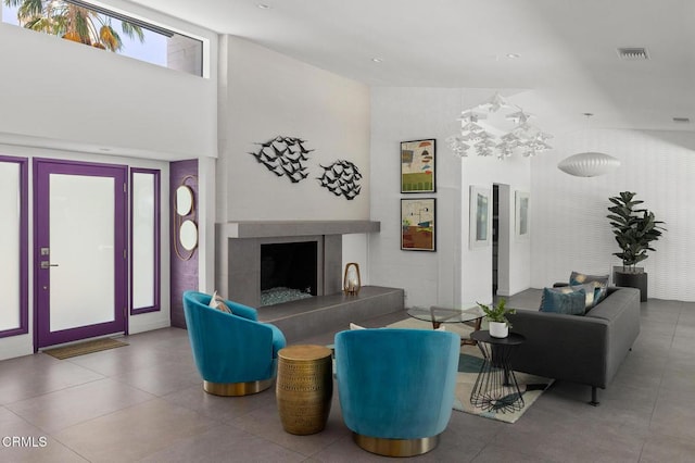 living room featuring a fireplace and a notable chandelier