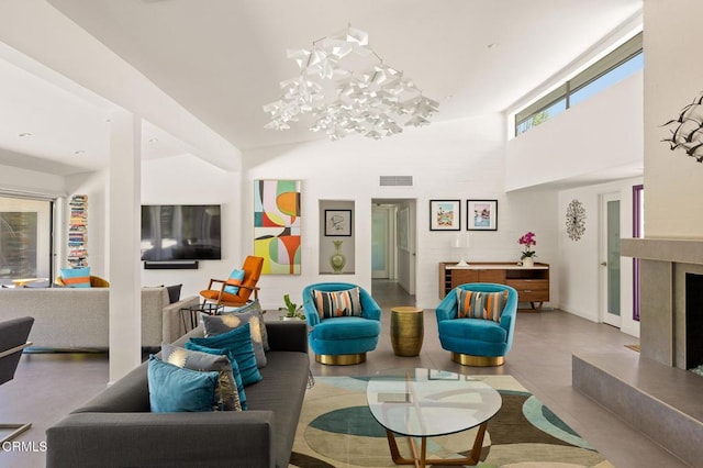 living room featuring a high ceiling and a notable chandelier