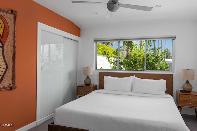 bedroom with multiple windows, ceiling fan, and a closet