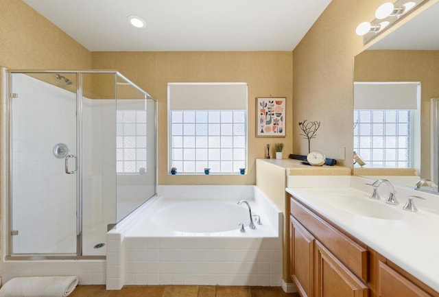 bathroom with tile patterned flooring, vanity, and separate shower and tub