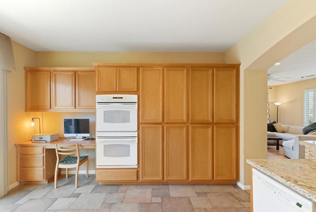 kitchen with ceiling fan, light stone countertops, and white appliances