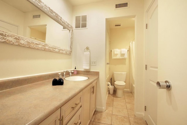 bathroom with tile patterned floors, vanity, and toilet