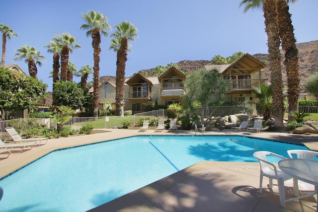 view of pool featuring a mountain view and a patio