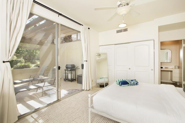 tiled bedroom featuring ceiling fan and a closet