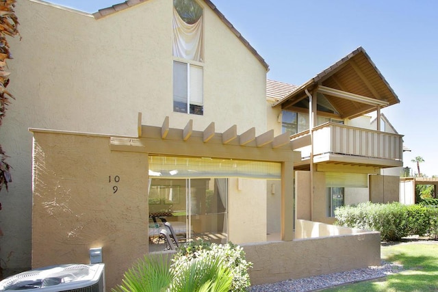 back of house with a balcony and central AC