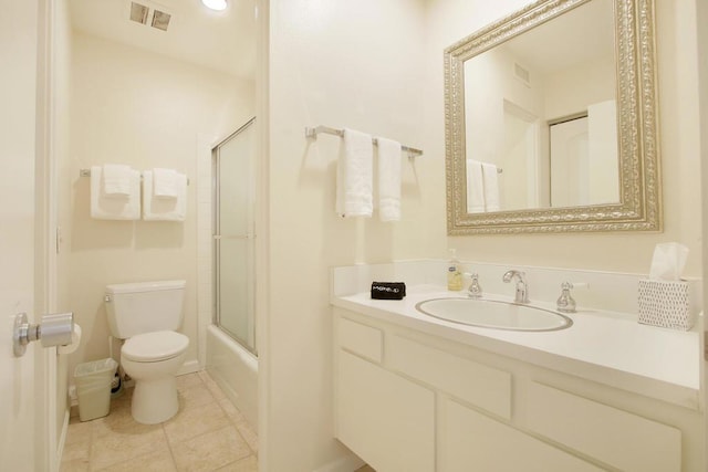 full bathroom featuring combined bath / shower with glass door, tile patterned floors, vanity, and toilet