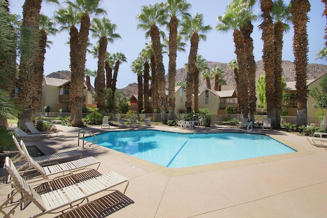 view of pool with a mountain view and a patio