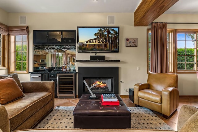 living room with bar, light tile patterned flooring, a healthy amount of sunlight, and beverage cooler