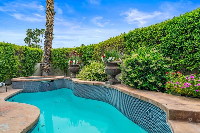 view of pool featuring an in ground hot tub