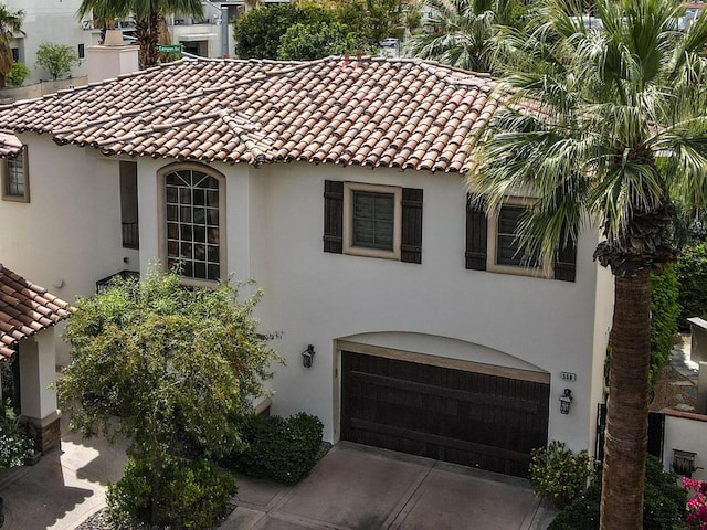 mediterranean / spanish home featuring a garage