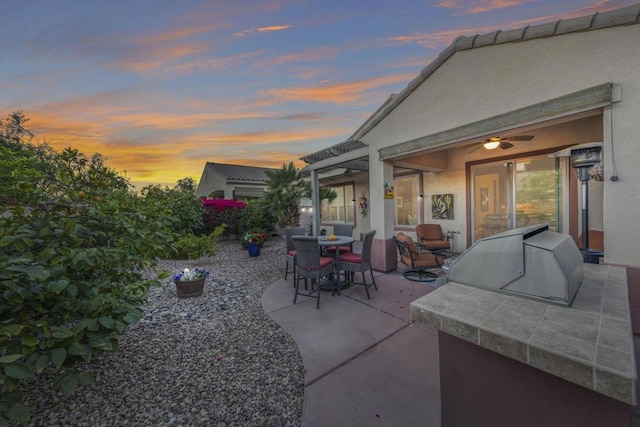 view of patio terrace at dusk