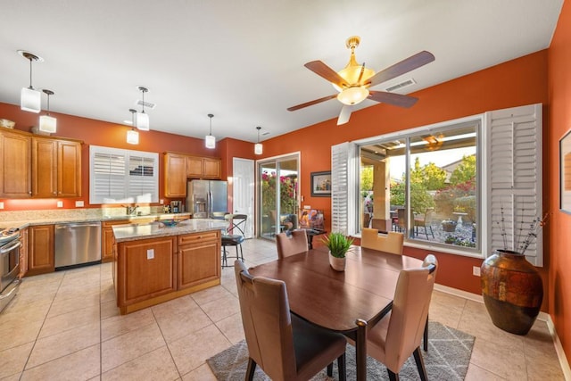 tiled dining area featuring ceiling fan