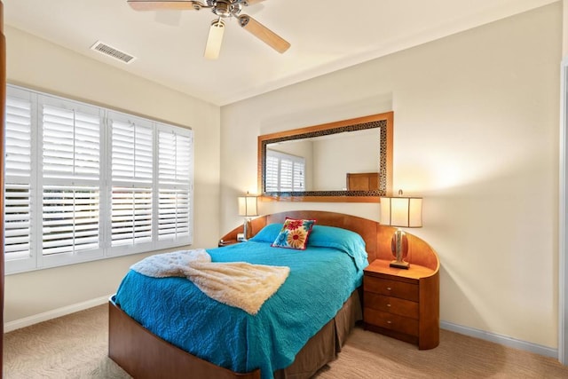 bedroom featuring light colored carpet and ceiling fan