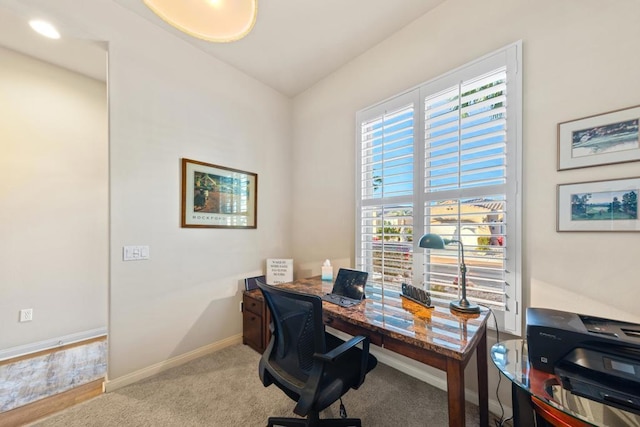 office area featuring light carpet