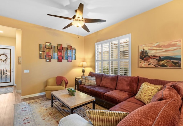 living room featuring ceiling fan and light hardwood / wood-style flooring