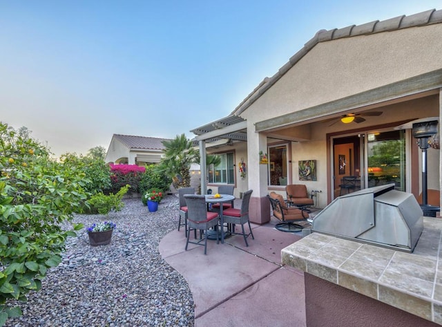 view of patio featuring an outdoor kitchen and ceiling fan