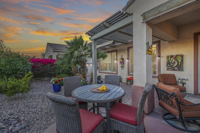 patio terrace at dusk with a pergola