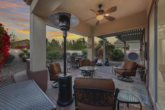 patio terrace at dusk with a pergola and ceiling fan