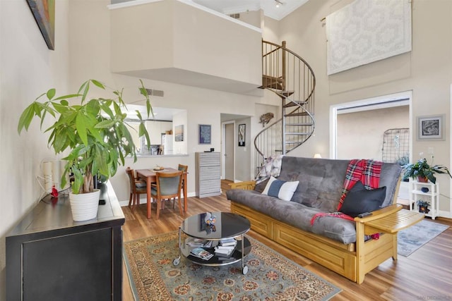 living room featuring hardwood / wood-style floors and a towering ceiling