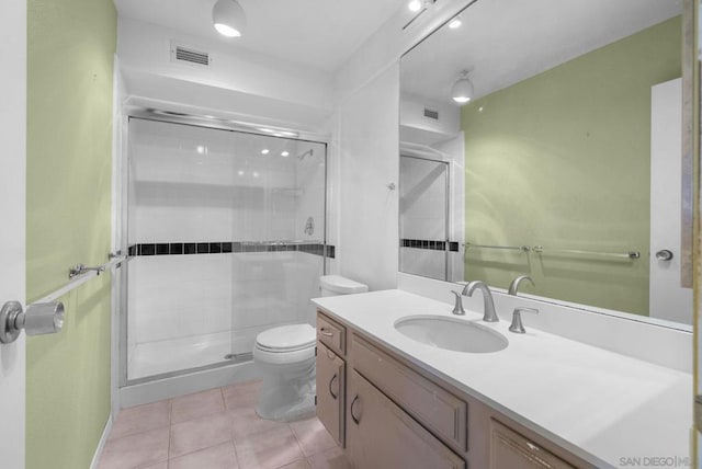 bathroom featuring vanity, an enclosed shower, tile patterned floors, and toilet