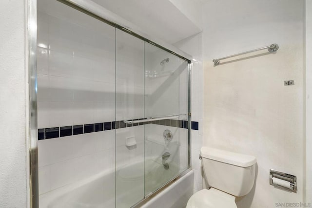 bathroom with enclosed tub / shower combo and toilet