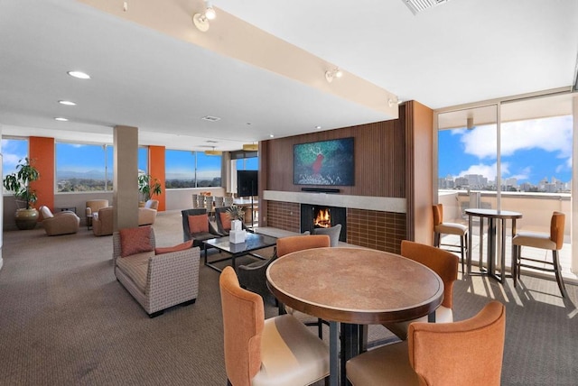 dining area with a wall of windows and carpet