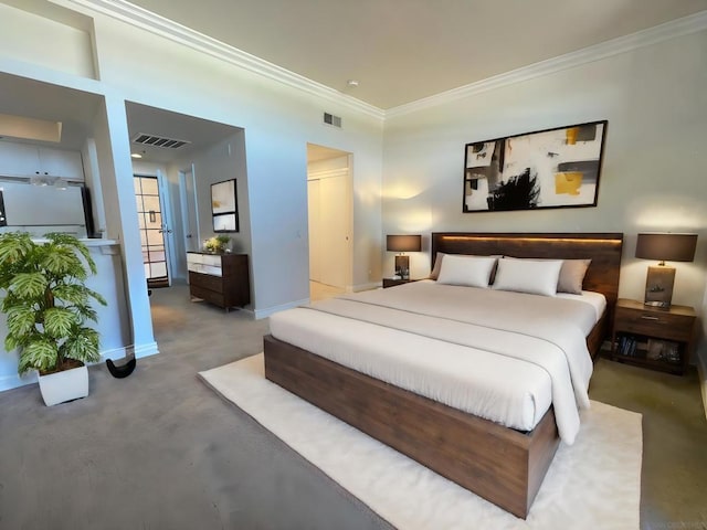 bedroom with ornamental molding and concrete floors