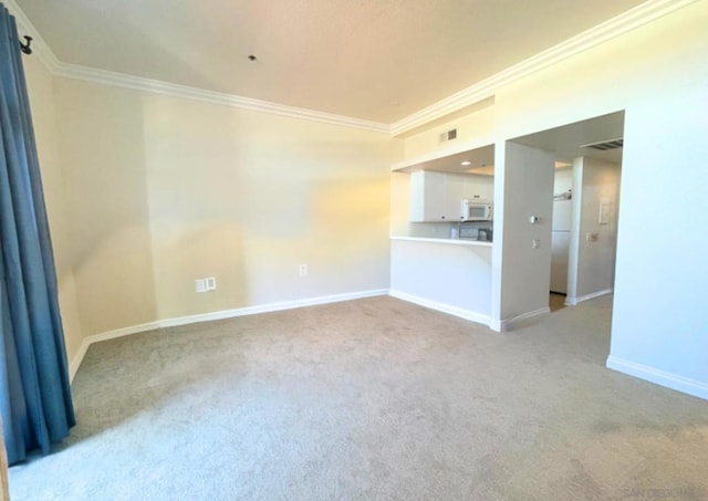 carpeted spare room featuring crown molding