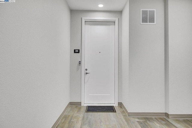 doorway to outside with light wood-type flooring