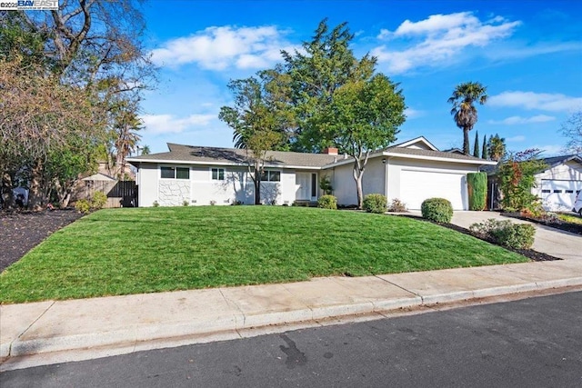 single story home featuring a garage and a front lawn