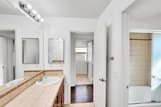 bathroom with enclosed tub / shower combo and vanity