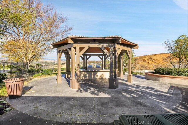 surrounding community with a mountain view, a gazebo, and a patio