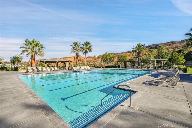 view of swimming pool featuring a mountain view and a gazebo