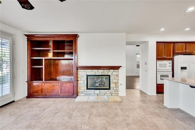 unfurnished living room with a fireplace, light tile patterned flooring, and recessed lighting