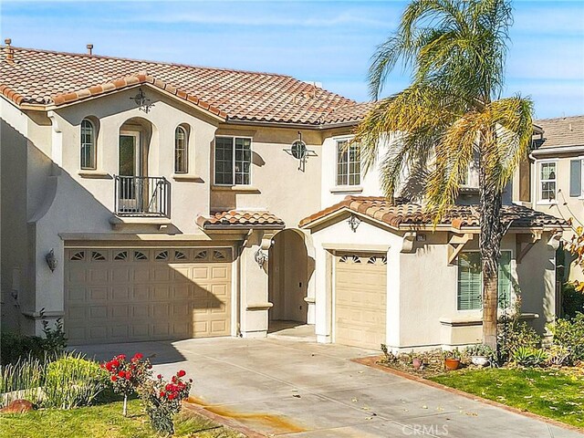 mediterranean / spanish-style home with a garage