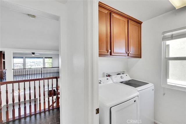 laundry room featuring cabinet space, a ceiling fan, dark wood finished floors, and washer and dryer