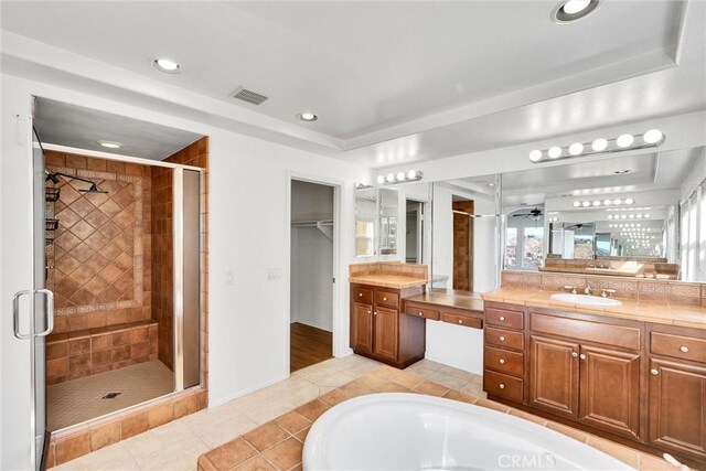 bathroom featuring shower with separate bathtub, vanity, and tile patterned flooring