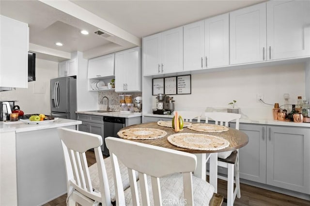 kitchen featuring sink, gray cabinets, stainless steel appliances, and white cabinets