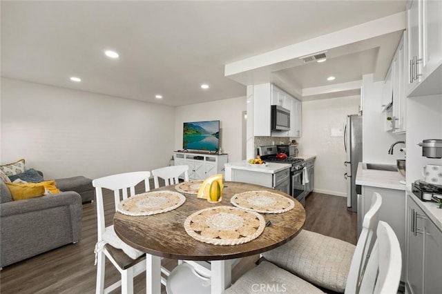 dining room featuring dark hardwood / wood-style floors and sink