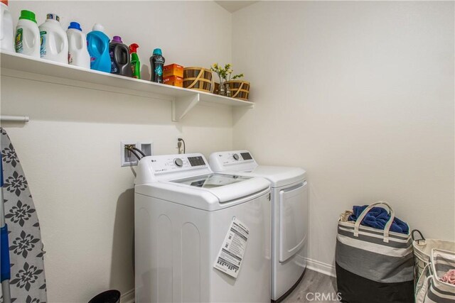 laundry area featuring washer and dryer and hardwood / wood-style floors