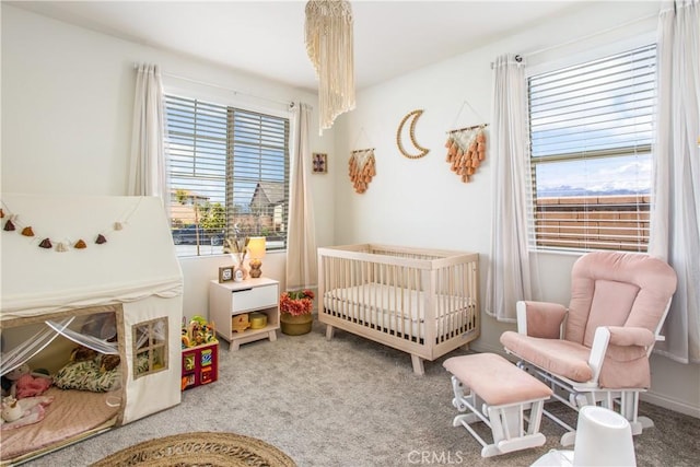 carpeted bedroom with a nursery area