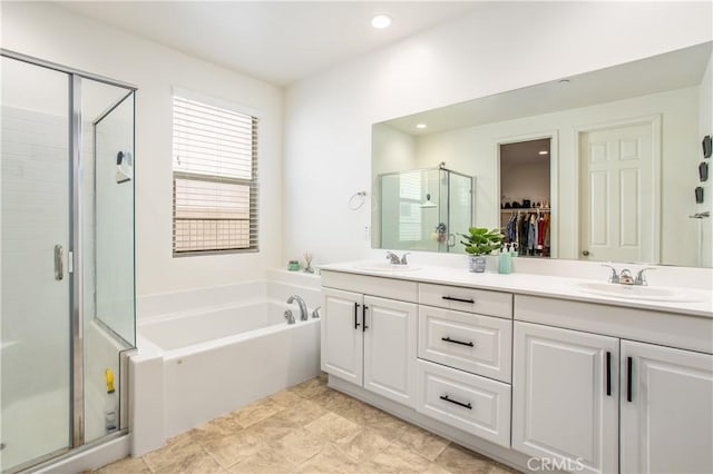 bathroom with vanity and independent shower and bath