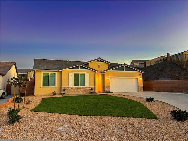 ranch-style house with a garage and a yard