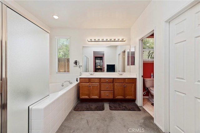 full bathroom with plenty of natural light, toilet, shower with separate bathtub, and vanity