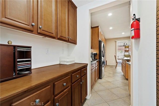 kitchen with stainless steel fridge and light tile patterned floors